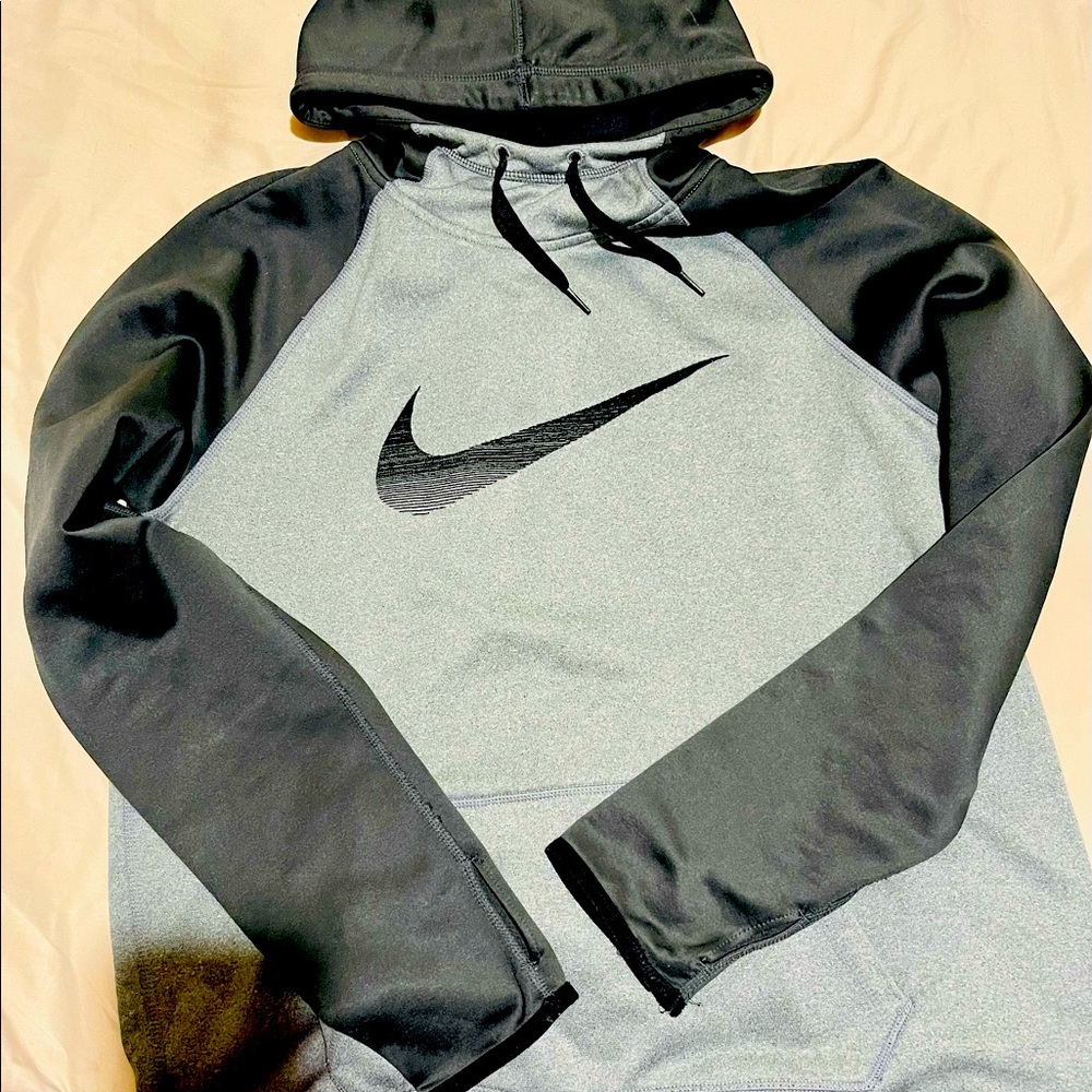 Woman’s Large Nike hooded sweatshirt. Therma Fit material, gray and black color.